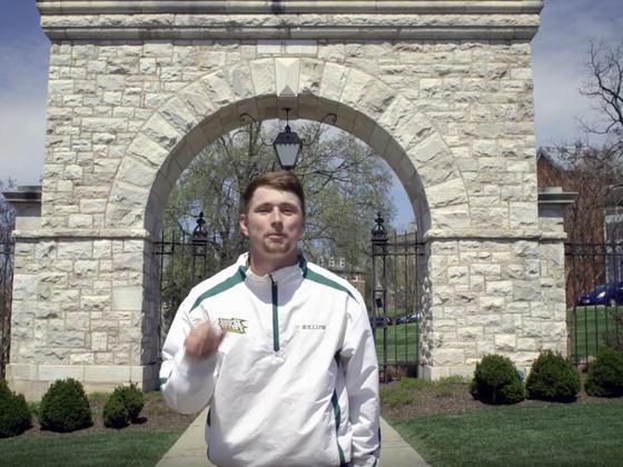 Student in front of Mcdaniel arch